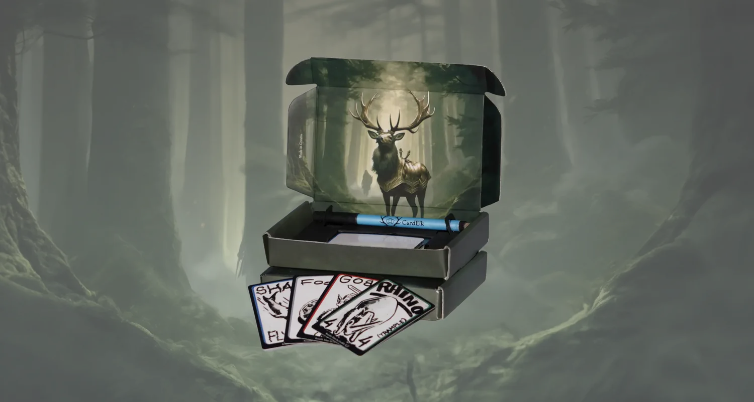 The CardElk Reusable Tokens box open in a forest, with the elk artwork inside the lid, the marker, and drawn shark, food, goblin and rhino tokens